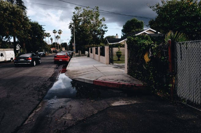 Columbus at Hamlin looking south. During rainy season, puddles form as the street has no sewers to drain rainwater.